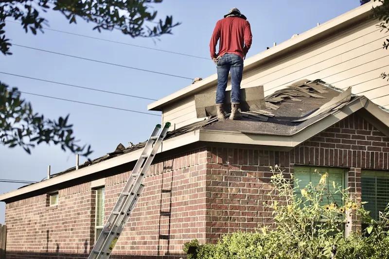 Professional roofer working on a residential roof in Jamesport
